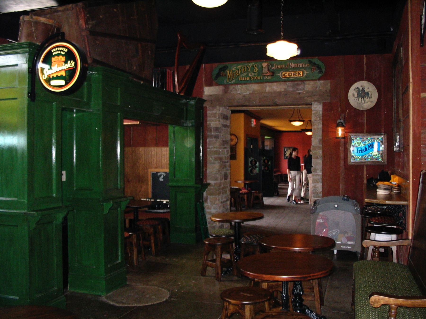Paneled green Irish pub snug with arched openings